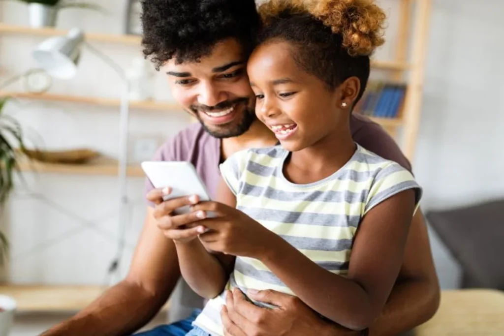 Parent having a calm conversation with child about phone use and online safety
