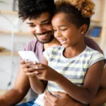 Parent having a calm conversation with child about phone use and online safety